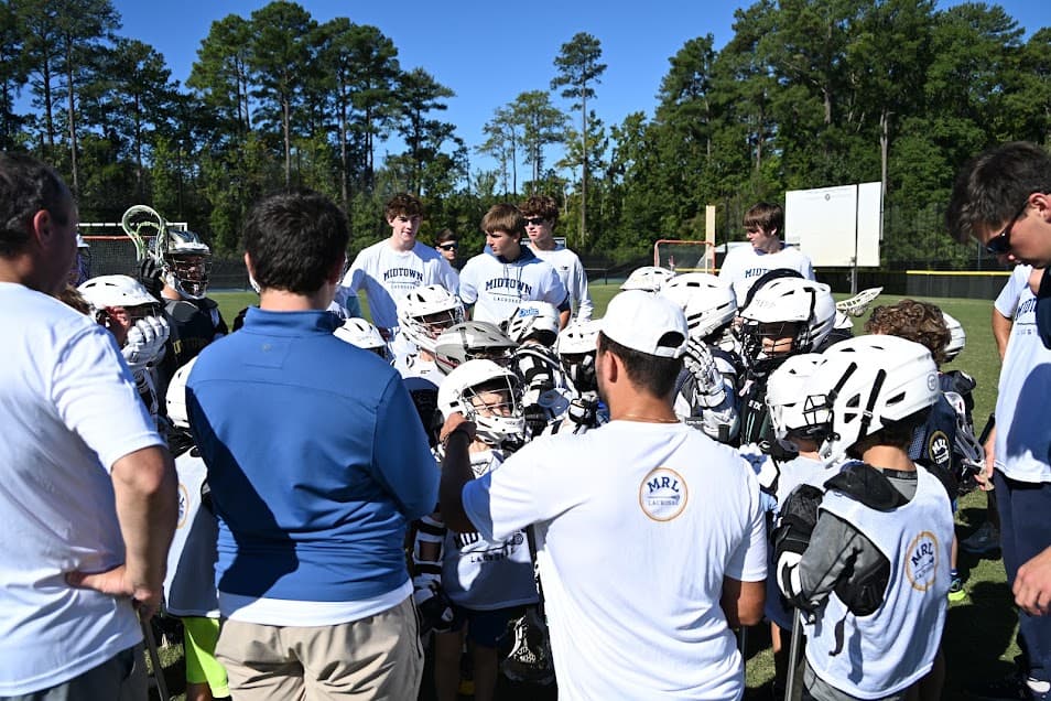 MRL players and coaches in a team huddle